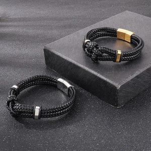 Close-up of braided leather bracelets with gold and silver magnetic metal clasps