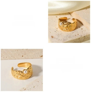 Macro detail of 18k gold plated stainless steel ring with lava texture and white pearl
