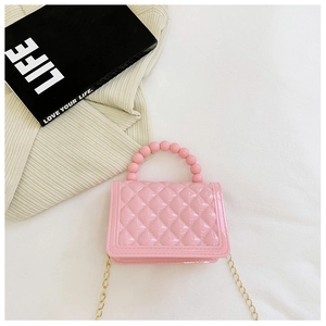 Close-up of pink quilted PVC jelly bag featuring beaded handle and golden chain strap