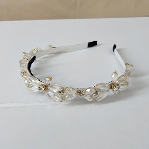 Close-up of handmade floral crystal headband with luxury rhinestones and woven white band
