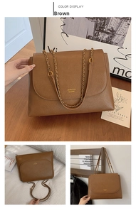 Detail of brown leather chain strap bag with textured surface and gold metal hardware