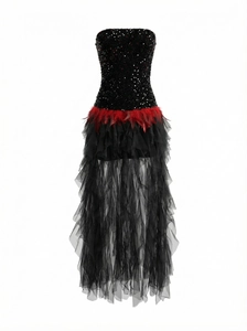 Detail of red feather accents on black sequin strapless dress with layered mesh skirt
