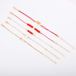 Close-up of a 5-piece bracelet set with red beads, gold leaves, and heart charms