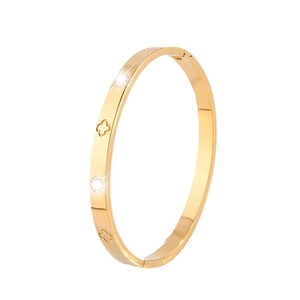 Titanium steel gold bangle with clover engravings and polished surface for women