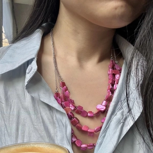 Three-layer bohemian beaded necklace featuring pink polished stones and silver chains