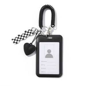 Detail of black matte card holder with heart charm and checkerboard pattern keychain