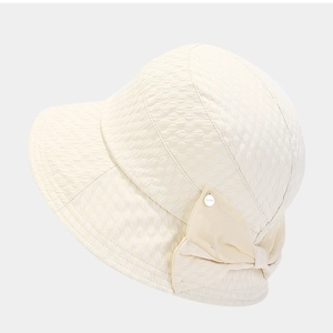 Beige bubble texture bucket hat with elegant side bow and metallic logo detail