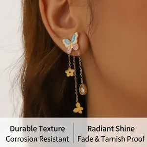 Macro detail of butterfly tassel earring with colorful enamel, floral charms and zircon