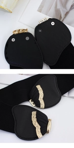 Detail of vintage gold metal buckle and black elastic waist belt with leather patches