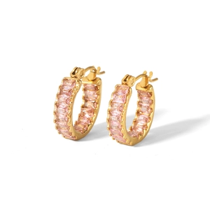 Close-up of gold stainless steel hoop earrings with baguette cut pink zircons