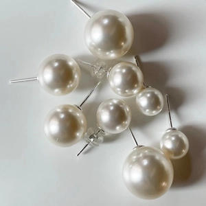 Set of 925 sterling silver pearl stud earrings in various sizes on white background