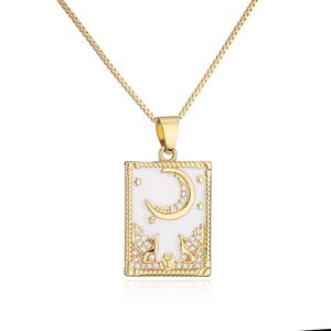 Detail of 18K gold plated necklace with white enamel star and moon animal pendant