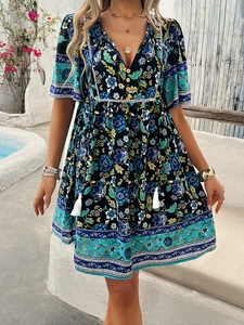 Detailed V-neck and tassel drawstrings on a black floral boho print summer dress