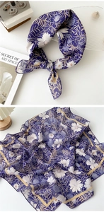 Detail of floral purple cotton linen scarf with elegant white patterns and soft texture