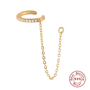 Detail of 925 sterling silver gold ear cuff with dangling chain and zircon stones