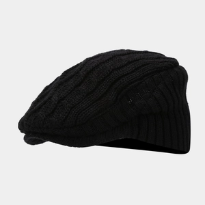 Detail showing the chunky cable knit texture and brim of this black winter beret hat