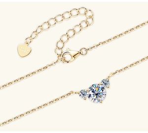 Macro shot of gold-plated S925 silver heart necklace with three sparkling moissanite stones
