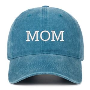 Close-up of white MOM embroidery on vintage washed blue denim cotton baseball cap