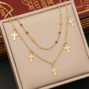 Double-layered gold necklace with colorful beads and minimalist cross pendants on display