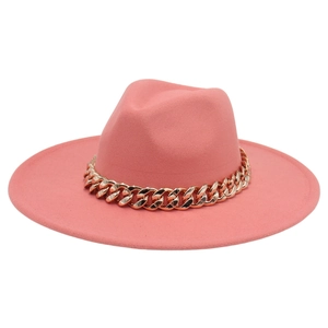 Detail of pink fedora hat featuring a bold gold chain trim on high-density felt fabric
