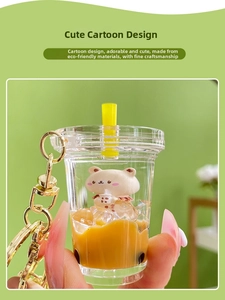 Close-up of bear-shaped liquid sand keychain showing floating pearls and bubble tea design