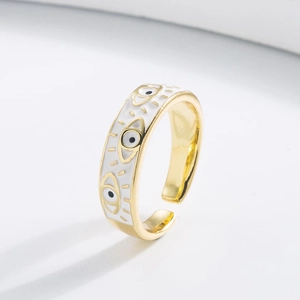 Close-up of gold evil eye open ring with white enamel detail and adjustable band structure