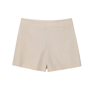 Detail of beige cotton linen shorts with natural texture on a clean white background