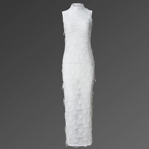 Close-up of the white sleeveless maxi dress featuring intricate shredded fringe texture