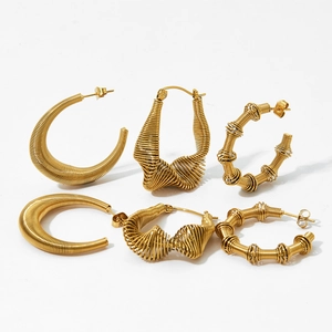 Three pairs of twisted gold stainless steel C-shaped hoop earrings with textured finish