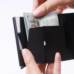 Close-up of minimalist black RFID carbon fiber wallet with card slots and cash compartment