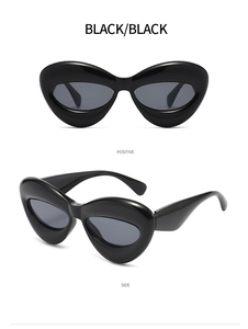 Front and side views of chunky black cat eye sunglasses with a futuristic alien design