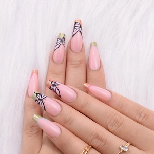 Detailed view of long French press-on nails with pink base and black butterfly patterns