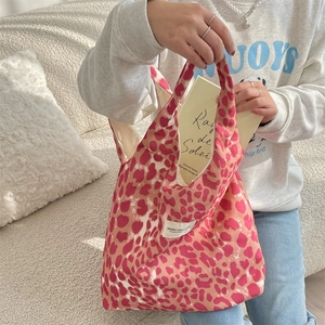 Detail of pink leopard print canvas tote bag with soft handles and fabric label