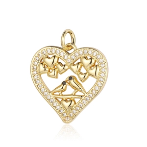 Detailed close-up of a heart-shaped gold pendant with bird motifs and zircon stones