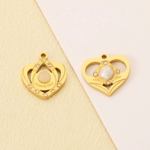 Detailed macro view of gold heart pendants with rhinestones and I LOVE YOU engraving