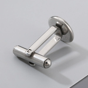 Detailed view of a polished silver stainless steel cufflink base with bullet back closure