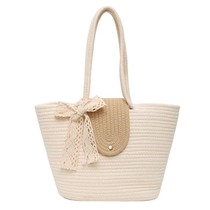 Beige woven tote beach bag with lace bow and leather flip cover for summer style