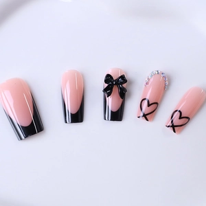 Long coffin press-on nails featuring black French tips, 3D bows and rhinestone accents
