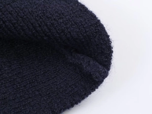 Detail of navy blue knit fabric showing soft texture and premium thermal material