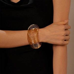 Chic multi-layer gold spiral cuff bracelet featuring a geometric hollow wrap design