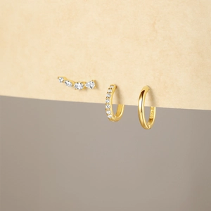Detail of gold S925 sterling silver hoop earrings set with zircon stones and S925 stamp
