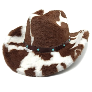 Detail of cow print plush cowboy hat with faux leather band and turquoise studs