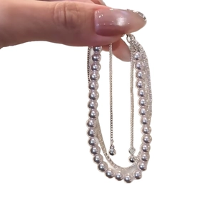 Elegant multi-layer pearl bracelet featuring rose zircon and silver metal chains for women