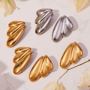 Polished stainless steel geometric fan earrings in gold and silver finish on marble