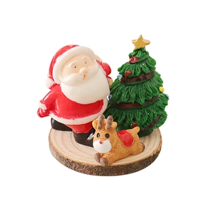 Miniature Christmas resin figurine set with Santa and reindeer on round wooden base