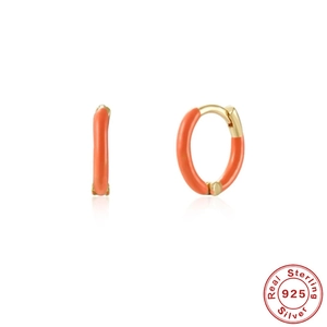Detail view of orange enamel S925 sterling silver hoop earrings with gold finish