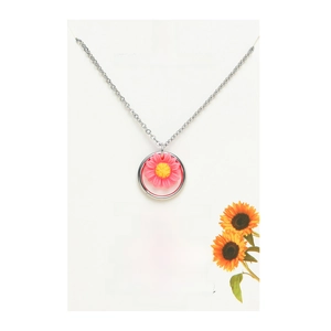 Detail of sunflower necklace with pink resin petals on a premium white display card