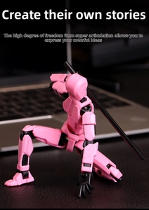 Pink Dummy 13 action figure in kneeling pose with black sword on office desk