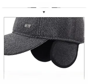 Detailed view of winter baseball cap with ear flaps and wool blend twill fabric texture