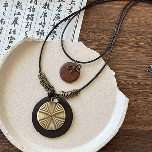 Bohemian bow pendant necklace set with vintage round wood and golden spiral charms